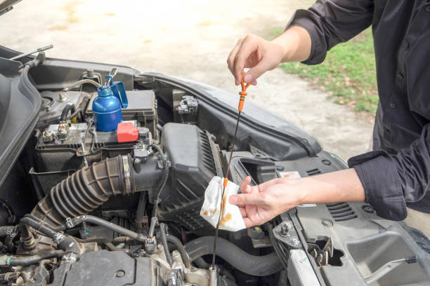 istock Cropped Hand Of Man Working On Car In Garage 1146210892
