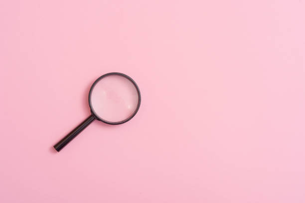 istock High Angle View Of Magnifying Glass Over Pink Background 1146211818