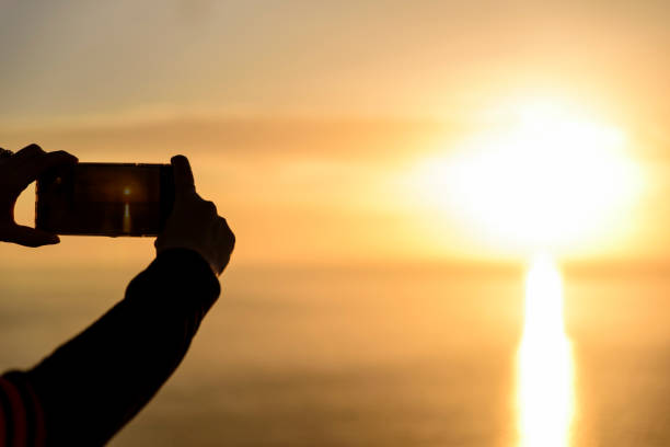 istock photographing sunset with smart phone 1146212042