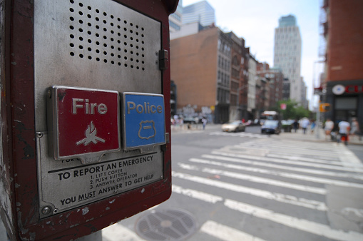 Brooklyn, New York City, USA : 14th July 2014 : Close up picture of a Fire and Police Emergency call box with some buildings in the background located in Brooklyn, NYC, USA