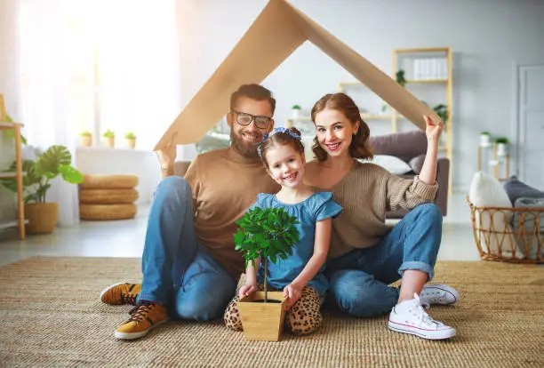 Photo of concept housing   young family. Mother father and child in new house with  roof at home