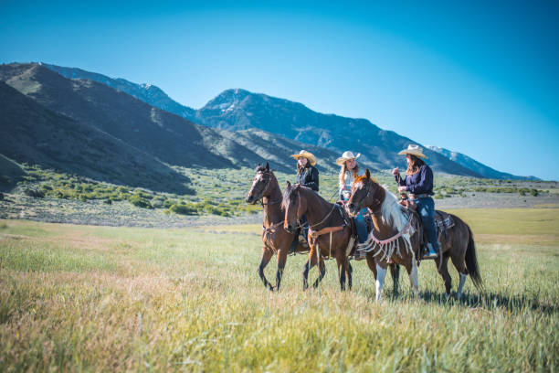 istock Western Horsewomen Galloping Through Utah Grassland 1146213023