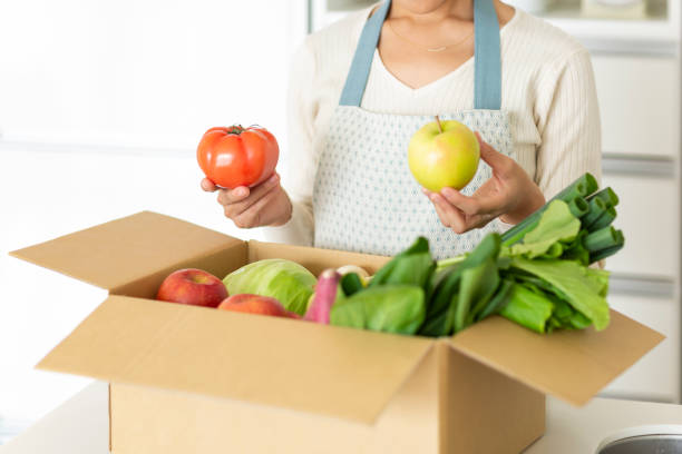 istock A cardboard box containing various vegetables and a housewife 1146213378