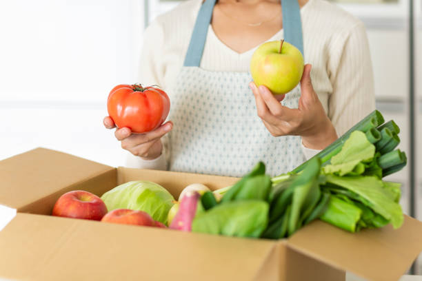istock A cardboard box containing various vegetables and a housewife 1146213385