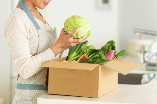 istock A cardboard box containing various vegetables and a housewife 1146213416