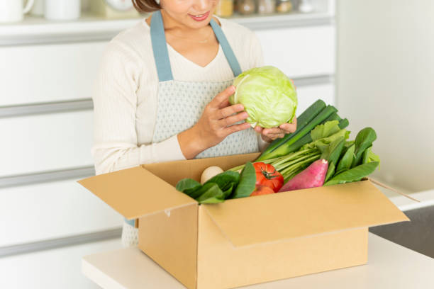 istock A cardboard box containing various vegetables and a housewife 1146213417