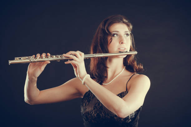 istock Woman playing transverse flute on black. 1146215262