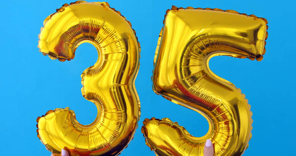 istock Gold foil number 35 celebration balloon on a blue 1146216042