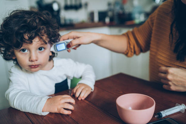 istock Measuring little boy's temperature 1146216162