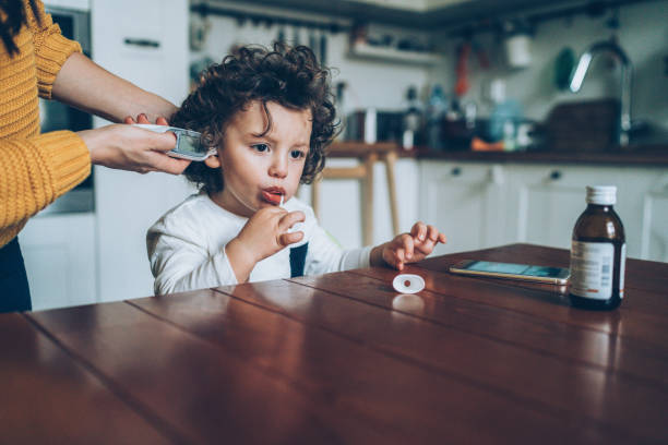 istock Measuring little boy's temperature 1146216174