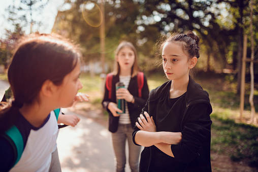 Girl bullying girl at schoolyard