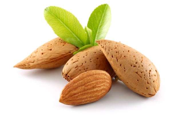 istock Group of almonds with leaves isolated on white 1146217891