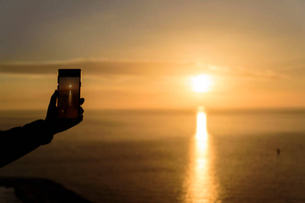 istock photographing sunset with smart phone 1146218937