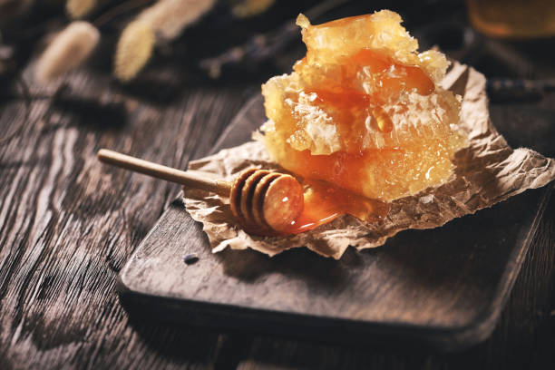 istock Honey Dipper and honyecomb 1146219101