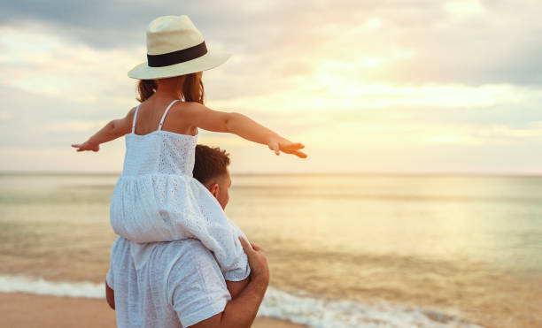 istock father's day. Dad and child daughter playing together outdoors on a summer 1146219164