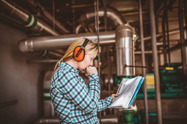 istock Young Female Technician is Checking Heating System in Boiler Room 1146224119