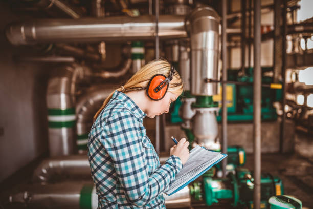 istock Young Female Technician is Checking Heating System in Boiler Room 1146224133