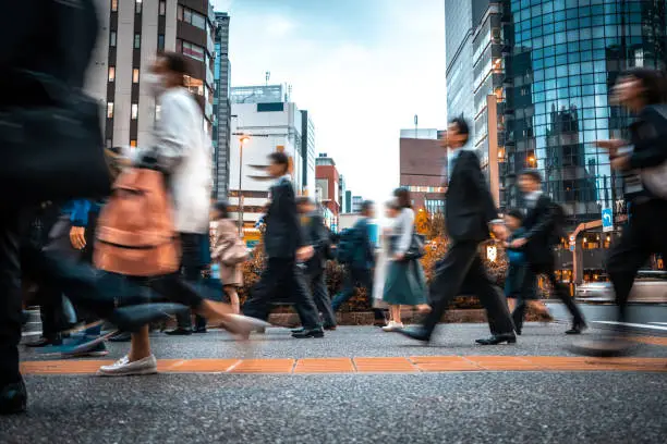 Photo of Blurred business people on their way from work