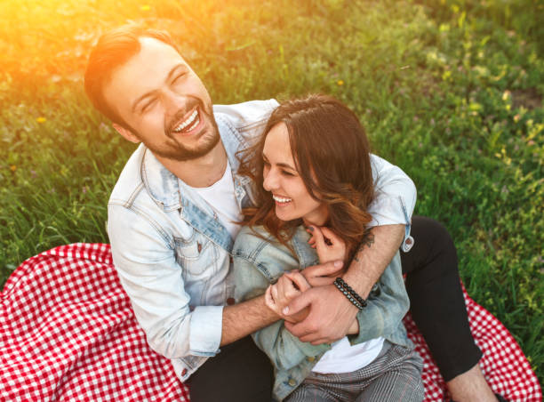 istock Laughing happy couple on plaid in sunlight 1146224455