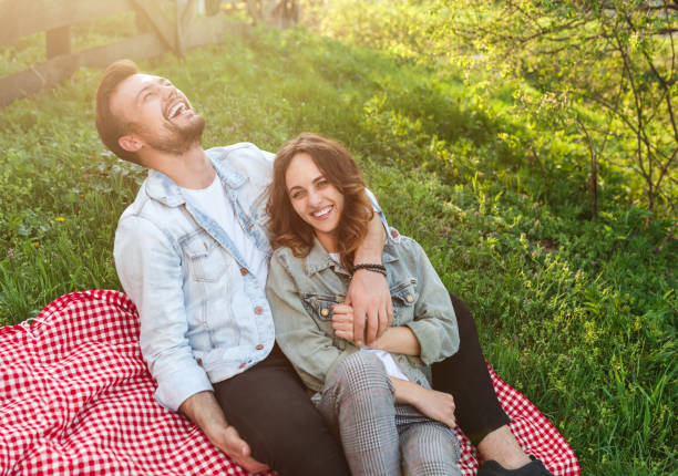 istock Cheerful couple sitting on ground 1146224493