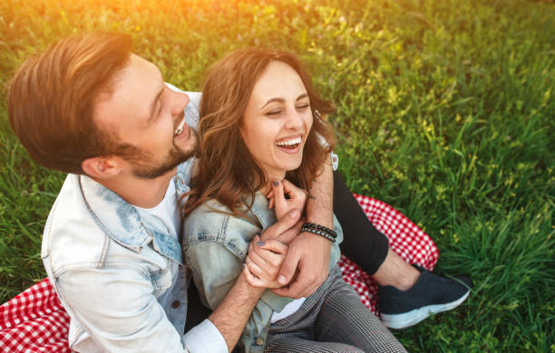 istock Laughing couple hugging on grass 1146224512