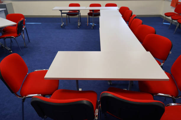 istock White school tables with red chairs in a classroom 1146229677