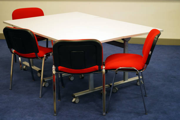 istock White school tables with red chairs in a classroom 1146229683