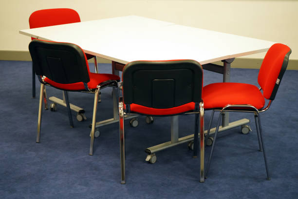 istock White school tables with red chairs in a classroom 1146229723