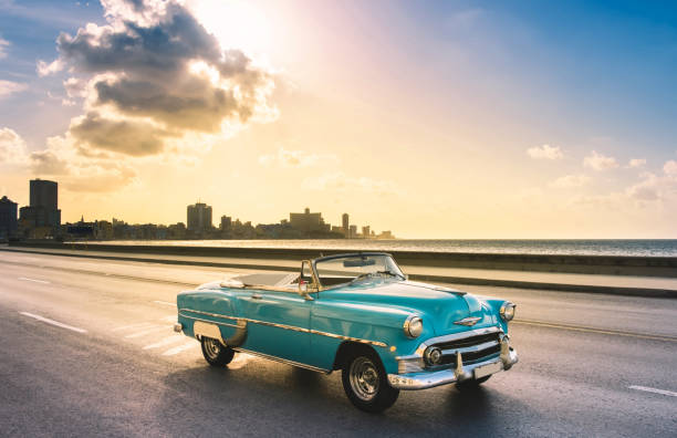American blue 1953 convertible convertible vintage car on the promenade Malecon in the evening sun in Havana City Cuba - Serie Cuba Reportage stock photo