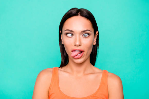 Close up photo portrait of funny funky playing fool making faces she her girl sticking tongue out watching in different ways isolated pastel background Close up photo portrait of funny funky playing fool making faces she her girl sticking tongue out watching in different ways isolated pastel background. squint eyes stock pictures, royalty-free photos & images