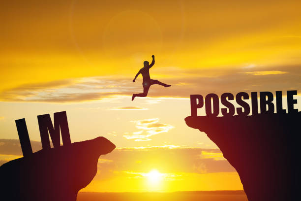 Man jumping over impossible or possible over cliff on sunset background Man jumping over impossible or possible over cliff on sunset background. Business concept idea possible stock pictures, royalty-free photos & images