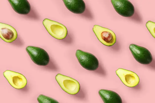 Avocado colorful pattern on a pastel pink background. Summer concept. Flat lay.