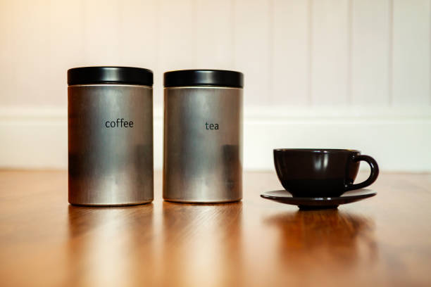 istock Tea and coffee tin and black coffee cup on a vintage background 1146236531
