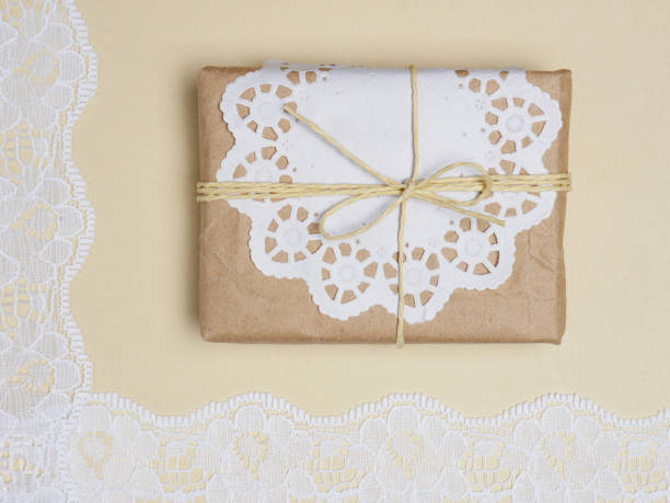 istock White laces on a beige background with gift 1146238739