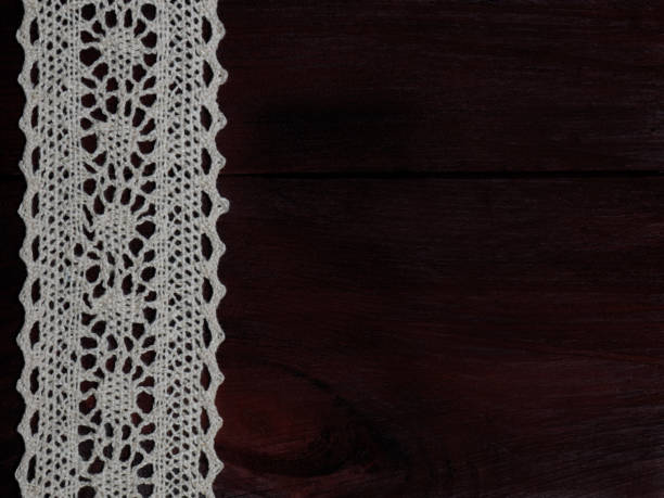 istock White laces on a brown wooden background vertically 1146238925