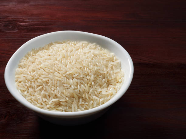 istock Raw Basmati rice in a white bowl on a brown wooden background 1146240142