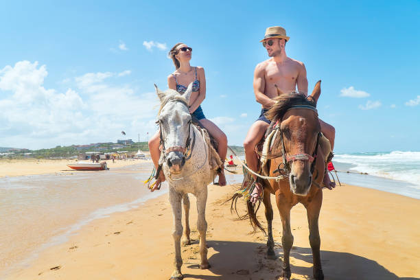 istock Young Couple riding a horse on the beach 1146240189