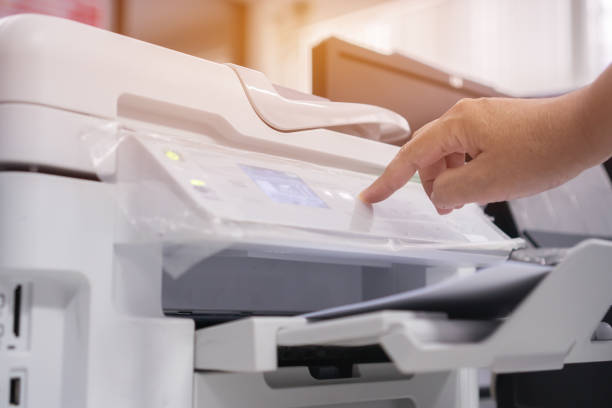 istock Business office Concept : Hand Businessman press button on panel of printer for process of paperwork on laser print cartridge, lay down or take papers from laser office copy machine at Busy Offices background 1146240431