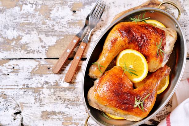 istock Chicken legs baked with orange slice and rosemary. 1146240510