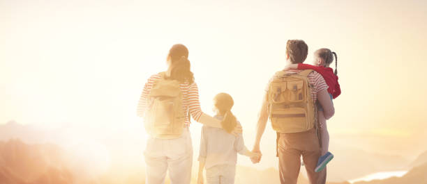 istock happy family at sunset. 1146241448