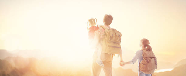istock happy family at sunset. 1146241449