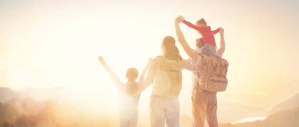 istock happy family at sunset. 1146241469