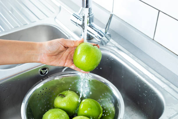 istock Washing Green Apples 1146241558