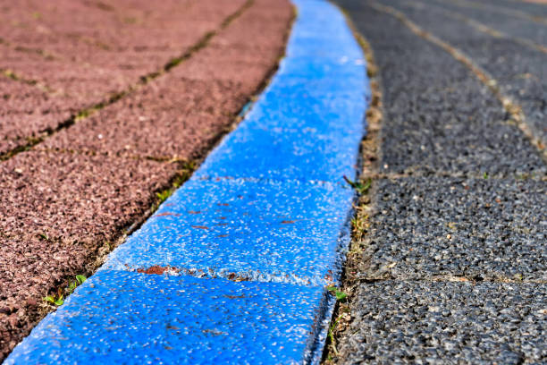 istock Cobblestone pavement lines in blue, red and grey. Road marking 1146241853
