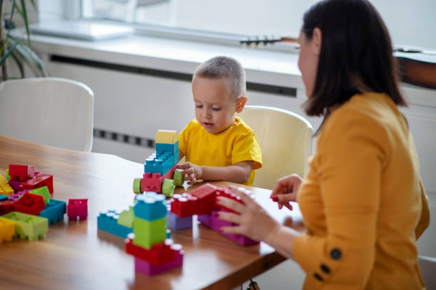 istock Mother and son having fun at home, playing with cubes 1146242633