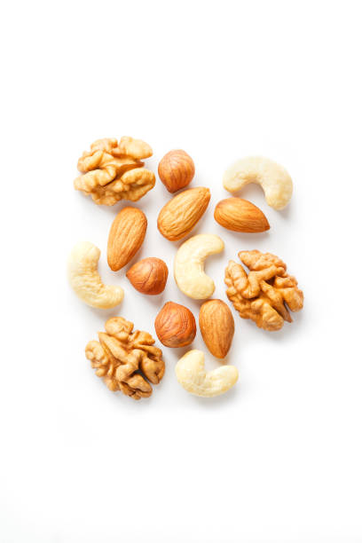 istock Isolated nuts pattern background. Walnut, cashew, almond and hazelnut on white background. View from above. 1146242644