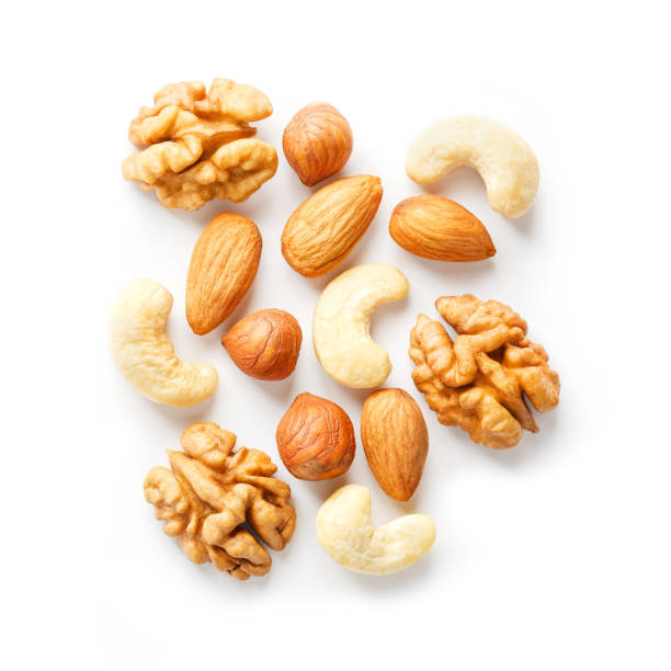 istock Isolated nuts pattern background. Walnut, cashew, almond and hazelnut on white background. View from above. 1146242735