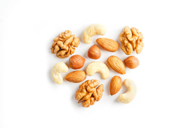 istock Isolated nuts pattern background. Walnut, cashew, almond and hazelnut on white background. View from above. 1146242943