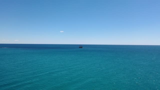 Tall ship alone on a vast blue sea