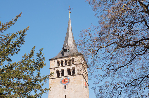 St. Martin's church near Klostersee lake, Sindelfingen, Germany. Beautiful old antient church tower. Spring trees. No people Scenic view